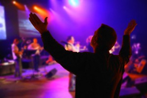 Man Worshipping as Religious Band Plays
